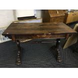 An early nineteenth century rosewood table with two drawers on claw feet.