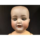 A bisque faced doll with composite body made by Simon Halbig.