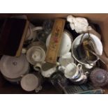 A box of various items including tea ware, figurine, book, pencil box, etc.