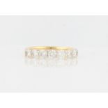 A hallmarked 18ct yellow gold diamond seven stone half eternity ring, set with seven round brilliant