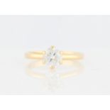 An 18ct yellow gold diamond solitaire ring, set with a round brilliant cut diamond, measuring