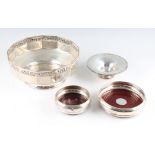 Two hallmarked silver wine coasters with wooden bases, together with two white metal bowls, (4).