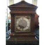 A classical temple style mantel clock with brass face. Height 42.5cm.