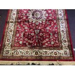 A cashmere rug having sharbas floral medallion design on red ground, approx.160cm by 230cm