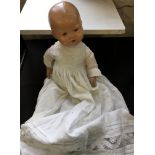 A doll in christening dress.