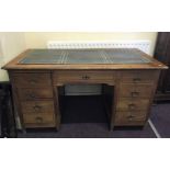 A mahogany inlaid nine drawer desk with leather insert to top.