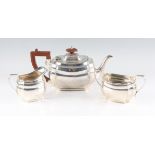 A silver tea set, comprising a tea pot, sugar bowl and milk jug, all hallmarked Birmingham 1936,