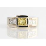 *A diamond ring set with a central princess cut treated (laser drilled) yellow diamond measuring