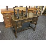 A small oak desk, string top stool and mirror.