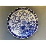 A blue and white charger with Japanese bird and blossom tree design. Diameter 47cm.