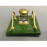 An Art Deco style inkwell on green glass base.