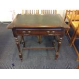 A mahogany single drawer leather insert topped fold over games table.