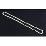 A matinee length string of cultured pearls, with open metalwork pearl set clasp, stamped Silver,