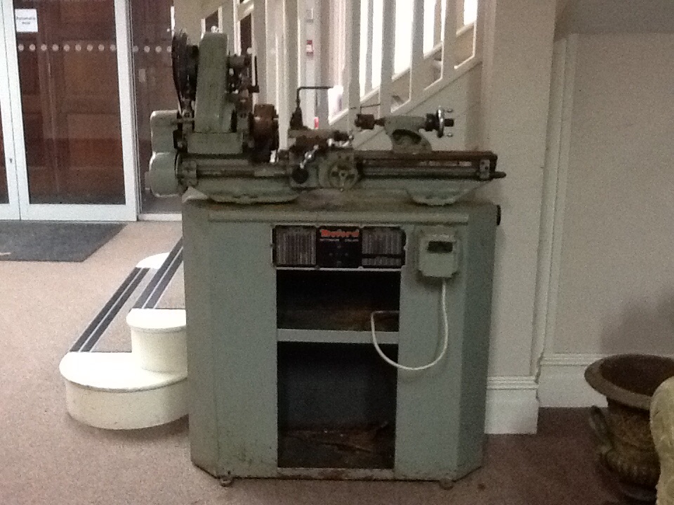 A Myford engineering lathe on stand with various chucks.