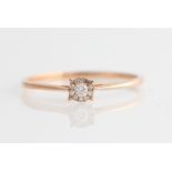 *A diamond cluster ring, set with a central round brilliant cut diamond, measuring approx. 0.05ct,