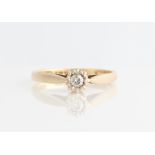 A 9ct yellow gold diamond solitaire ring, set with a round brilliant cut diamond, measuring