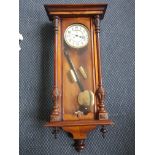 Walnut regulator wall clock with turned and fluted columns to side.