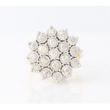 An 18ct yellow gold diamond cluster ring, illusion set with nineteen round brilliant cut diamonds,