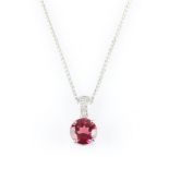 An 18ct white gold pink tourmaline and diamond pendant, set with a round cut pink tourmaline,