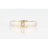 A 9ct white and yellow gold diamond solitaire ring, set with a princess cut diamond, measuring