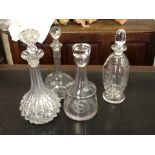 Four glass decanters with stoppers.