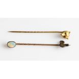 A novelty fox head stick pin, together with an opal cabochon stick pin, (2).