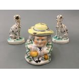 A pair of Staffordshire dalmations with a tobacco jar in the form of a man with hat, AF.