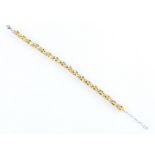 A citrine and cubic zirconia bracelet, set with oval cut citrines separated by two cubic