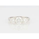 An 18ct white gold three stone diamond ring, set with three graduated round brilliant cut