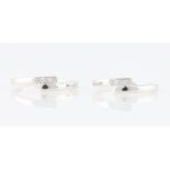 *Two diamond set cross over design rings, each set with two round brilliant cut diamond accents,