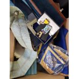 A box containing a selection of Masonic items to include aprons ad cuffs and various medals, books