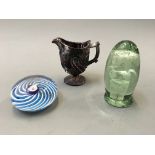 A glass paperweight with blue and white spirals, a Victorian dump and an end of day glass jug.