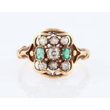 A diamond and emerald nine stone dress ring, set with seven round old cut diamonds of various