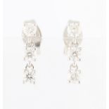 *A pair of diamond drop earrings, each set with three round brilliant cut diamonds, each measuring