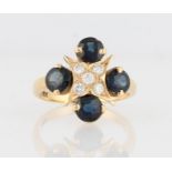 A sapphire and diamond dress ring, set with five round brilliant cut diamonds in star design, with