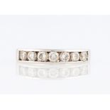 A seven stone diamond half eternity ring, channel set with seven round brilliant cut diamonds, total