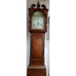 Oak and mahogany long cased clock with painted face and Roman numerals.