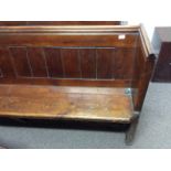 A pine church pew. Length approximately 237cm.