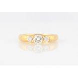 An 18ct yellow gold three stone diamond ring, set with three graduated round brilliant cut diamonds,