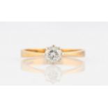 An 18ct yellow gold diamond solitaire ring, set with a round brilliant cut diamond, measuring