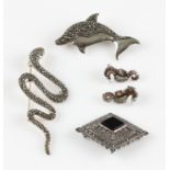 A marcasite set snake brooch, a marcasite and onyx diamond shaped brooch, a marcasite dolphin brooch