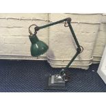 An industrial E.D.L. original paint green angle lamp.