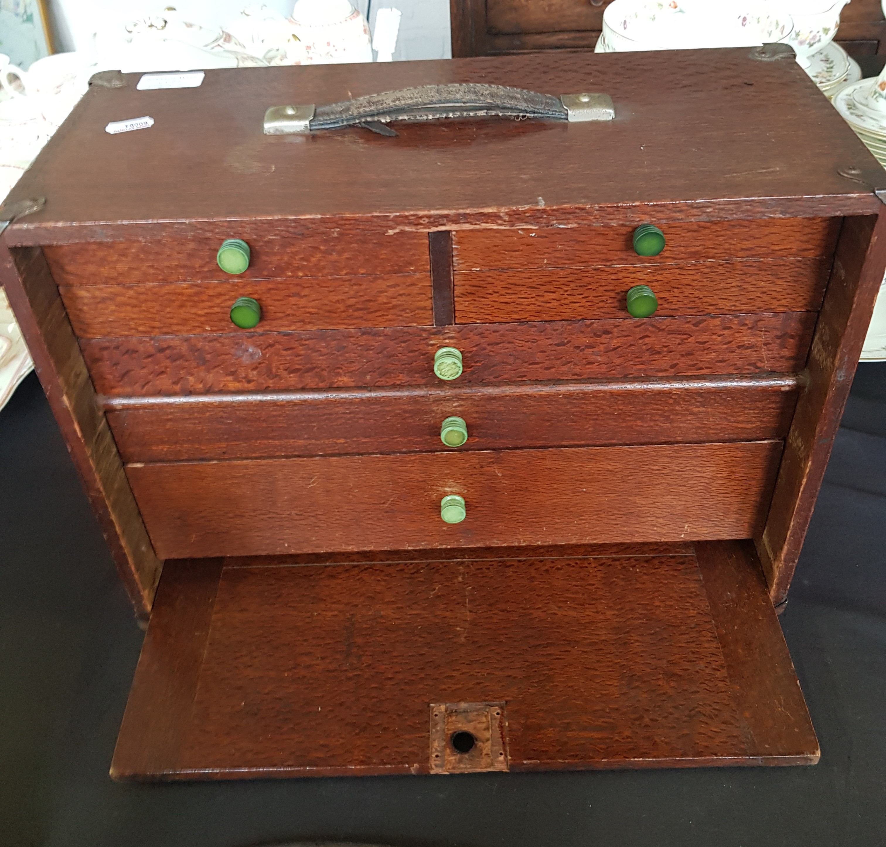 An oak portable engineers tool box with tools.