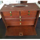 An oak portable engineers tool box with tools.