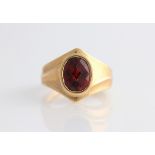 A gents garnet ring, set with an oval rose cut garnet, stamped 14k 585, ring size M½.