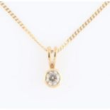 A hallmarked 9ct yellow gold diamond single stone pendant, set with a round brilliant cut diamond,