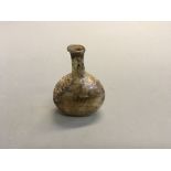 A Roman glass bottle. Height 8cm.