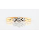 A diamond ring, set with three principal round brilliant cut diamonds, with further diamond