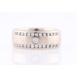 A gents 18ct white gold diamond set band, set with a central round brilliant cut diamond,