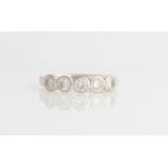 An 18ct white gold five stone diamond ring, set with five round brilliant cut diamonds, each